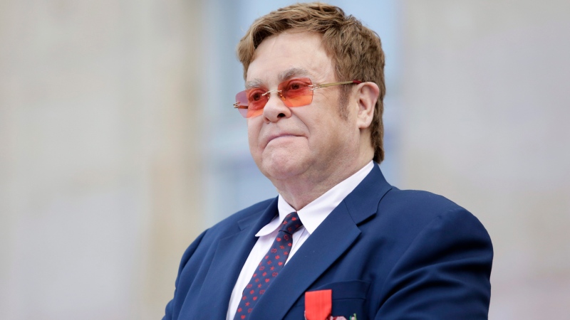 This June 21, 2019 file photo shows Elton John at a ceremony honoring him with the Legion of Honor in Paris. (AP Photo/Lewis Joly, Pool, File) 