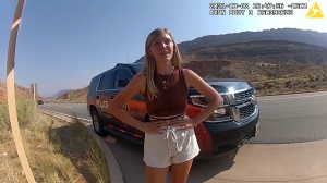 Local and federal authorities are looking for 22-year-old Gabby Petito, pictured here, talking to Moab police from bodycam footage, was reported missing by her family after she had been traveling with her boyfriend, Brian Laundrie. (Moab Police Department)