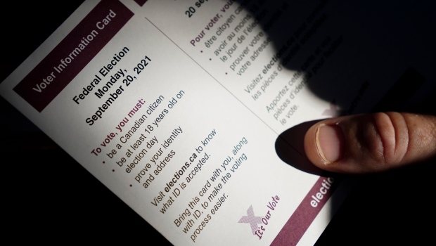 A person holds an Elections Canada voter information card after receiving it in the mail on Tuesday, Aug 31, 2021. (THE CANADIAN PRESS / Sean Kilpatrick)