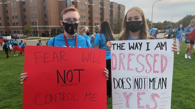 Students hold up signs at a rally against sexual violence at Fanshawe College in London, Ont. on Monday, Sept. 20, 2021. (Jim Knight / CTV News)