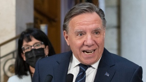 Quebec Premier Francois Legault reacts to the federal election, Tuesday, September 21, 2021 at the legislature in Quebec City. Quebec Minister Responsible for Canadian Relations and the Canadian Francophonie Sonia Lebel, left, looks on. THE CANADIAN PRESS/Jacques Boissinot 
