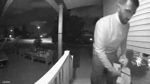 Footage captured by a doorbell camera appears to show newly elected Liberal MP George Chahal removing campaign literature from a doorstep in his riding of Calgary Skyview during the campaign. (Supplied)