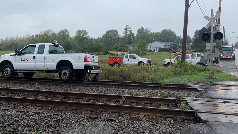 CN Rail trucks are parked near the rail crossing at Coronation Boulevard in Amherstview, Ont., near where a rail car derailed Wednesday, Sept. 22, 2021. No one was hurt. (Kimberley Johnson / CTV News Ottawa)