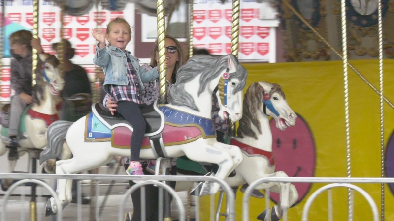 Jenna Ross and her daughter on the carousel at the Carp Fair. (Dave Charbonneau/CTV News Ottawa)