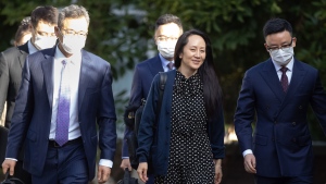Meng Wanzhou, centre, chief financial officer of Huawei, leaves her home in Vancouver, on Friday, September 24, 2021. THE CANADIAN PRESS/Darryl Dyck