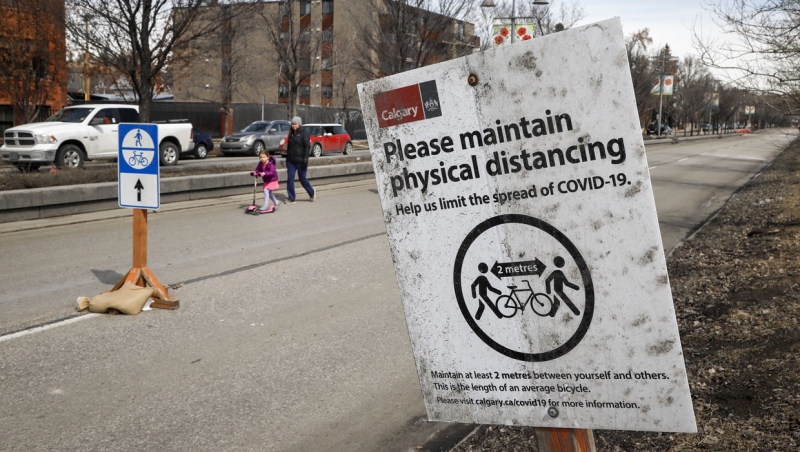 Pedestrians walk along a the closed eastbound lanes of Memorial Drive in Calgary, Thursday, April 9, 2020, amid a worldwide COVID-19 pandemic. THE CANADIAN PRESS/Jeff McIntosh
