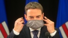 New Alberta Health Minister Jason Copping takes his mask off to give a COVID-19 update in Edmonton, Tuesday, Sept. 21, 2021. THE CANADIAN PRESS/Jason Franson