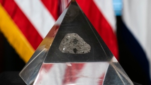 In this May 3, 2021, file photo, a fragment of the moon rock collected by astronaut John Young, commander of the Apollo 16 lunar mission, is displayed in Washington. (AP Photo/Manuel Balce Ceneta)