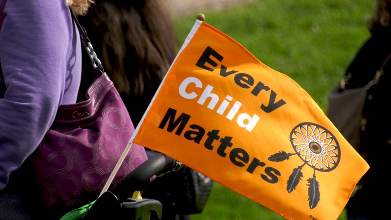 An every child matters flag waves in the wind on Thursday, Sept. 30, 2021 (Craig Momney/CTV News)