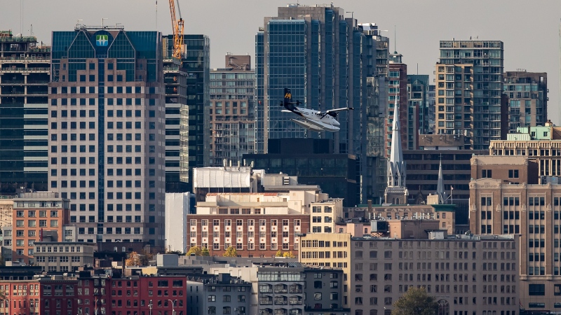 A Harbour Air seaplane passes the downtown skyline while on approach to land on the harbour in Vancouver on Friday, Oct. 1, 2021. (Darryl Dyck / THE CANADIAN PRESS)