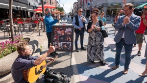 Bloc Quebecois leader Yves-Francois Blanchet listens to a busker while mainstreeting Friday, September 17, 2021 in Trois-Rivieres, Que. The Bloc won the riding by just 92 votes, and a recount was requested. THE CANADIAN PRESS/Ryan Remiorz 