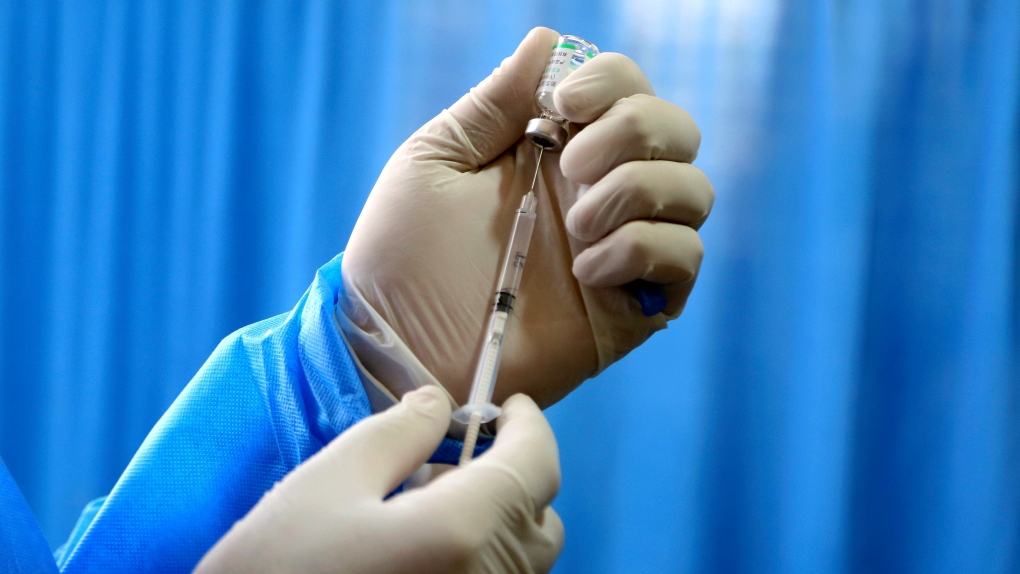 health worker prepares a Sinopharm COVID-19 vaccin