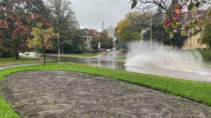 A driver creates a large splash while driving down a flooded street in Ottawa. Oct. 16, 2021. (Josh Pringle / CTV News Ottawa)