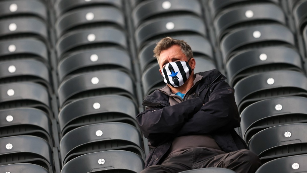 Newcastle fan wearing a mask