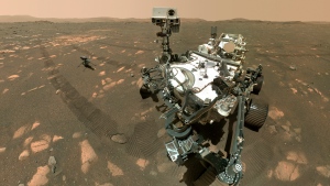 This April 6, 2021, image made available by NASA shows the Perseverance Mars rover and the Ingenuity helicopter about four metres behind. This composite image was made by the WASTON camera on the rover's robotic arm on the 46th Martian day, or sol, of the mission. (NASA/JPL-Caltech/MSSS via AP) 