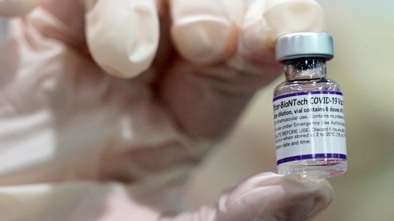 FILE - A healthcare worker holds a vial of the Pfizer COVID-19 vaccine at Jackson Memorial Hospital in Miami, in this Tuesday, Oct. 5, 2021, file photo. (AP Photo/Lynne Sladky, File) 