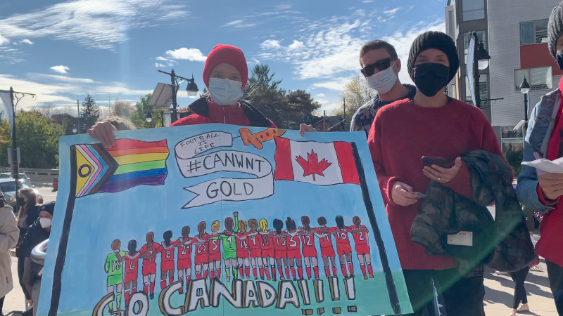 A fan holds up a homemade sign ahead of the friendly match between Canada's gold medal winning Olympic women's soccer team and New Zealand at TD Place in Ottawa. Oct. 23, 2021. (Jackie Perez/CTV News Ottawa)