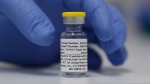 A vial of the Phase 3 Novavax coronavirus vaccine is seen ready for use in the trial at St. George's University hospital in London Wednesday, Oct. 7, 2020. (AP Photo/Alastair Grant) 
