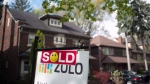 A sold sign is shown in front of west-end Toronto homes Sunday, May 14, 2017. THE CANADIAN PRESS/Graeme Roy 
