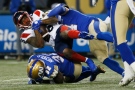 Winnipeg Blue Bombers' Adam Bighill (4) tackles Montreal Alouettes' Cameron Artis-Payne (26) during the second half of CFL action in Winnipeg Saturday, November 6, 2021. THE CANADIAN PRESS/John Woods