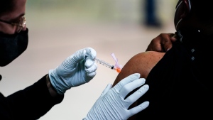 In this March 26, 2021, file photo, a person is pictured getting a COVID-19 vaccine. (AP Photo/Matt Rourke, File)