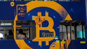 This May 12, 2021, file photo shows an advertisement for the cryptocurrency Bitcoin displayed on a tram in Hong Kong. (AP Photo/Kin Cheung, File) 