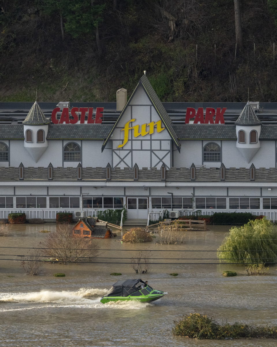 Boat speeds along a flooded highway 1