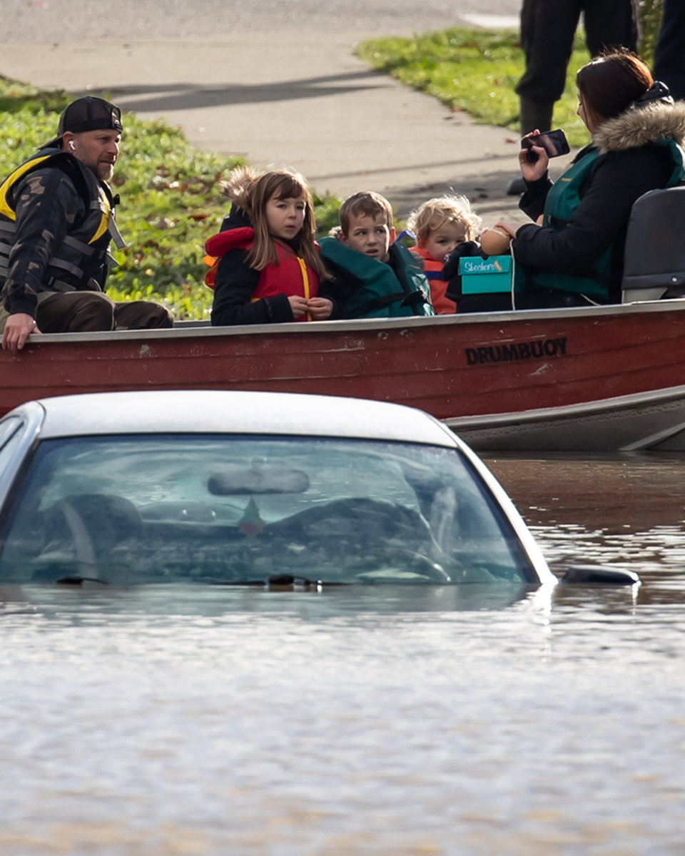 A woman and children being rescued