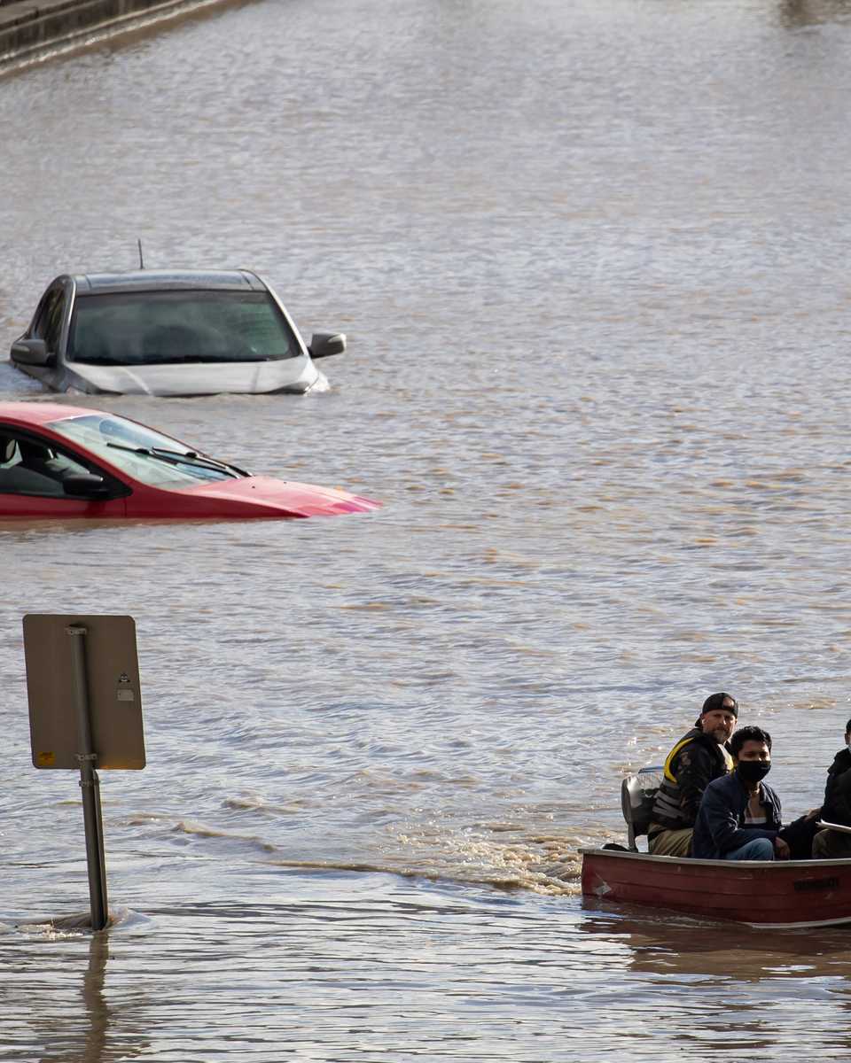 People being rescued by a boat in Abbotsford, B.C.