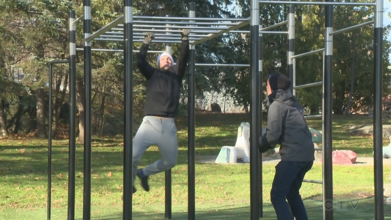 CTV News' Will Aiello and Pure Country's Josh Corbett get their sweat on using new outdoor exercise equipment at Sudbury's Bell Park. (CTV Northern Ontario)