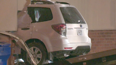 An SUV is removed from a hole in the exterior of a HomeSense store it drove into in Mississauga after hitting a pedestrian on Tuesday, Dec. 1, 2009.