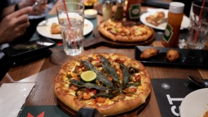 A pizza topped with a cannabis leaf is served to the customers at a restaurant in Bangkok, Thailand on Nov. 24, 2021.(AP Photo/Sakchai Lalit) 