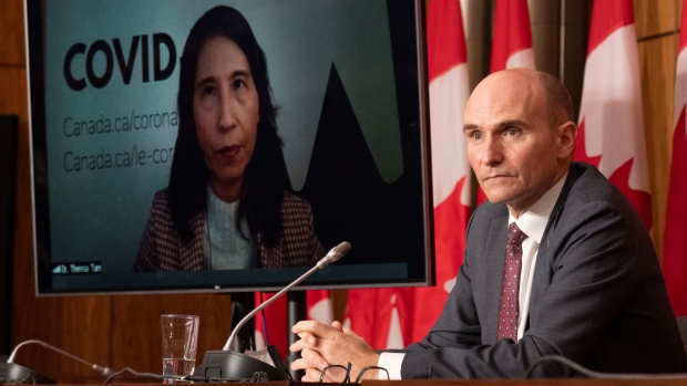 Health Minister Jean-Yves Duclos and Chief Public Health Officer Theresa Tam listen to a question during a news conference, Friday, November 26, 2021 in Ottawa. THE CANADIAN PRESS/Adrian Wyld 