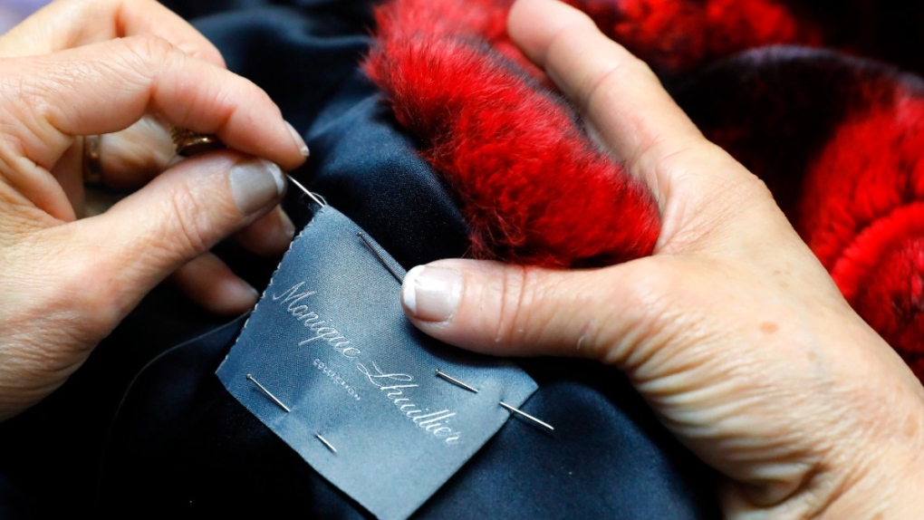 Sewing a label in a coat
