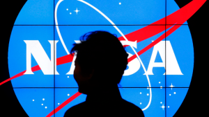 South Korean President Park Geun-hye walks past a NASA logo during a tour of projects and programs that are underway at the agency's Goddard Space Flight Center, Wednesday, Oct. 14, 2015, in Greenbelt, Md. (AP Photo/Patrick Semansky) 