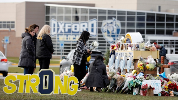 People gather at the memorial for the dead and wounded outside of Oxford High School in Oxford, Michigan on Dec. 3, 2021. (Jeff Kowalsky/AFP/Getty Images)