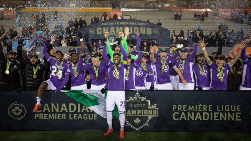 Pacific FC teammates celebrate with the North Star Shield after defeating Forge FC by a score of 1-0 during Canadian Premier League championship game action at Tim Hortons Field in Hamilton, Ont., Sunday, Dec. 5, 2021. THE CANADIAN PRESS/NICK IWANYSHYN