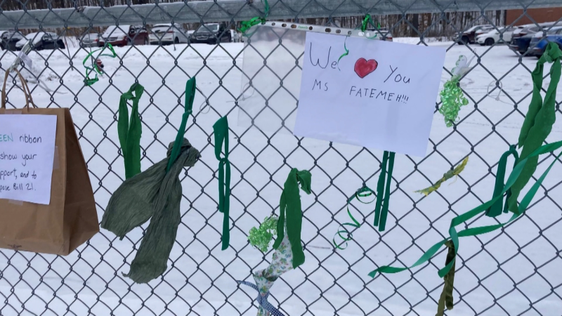 Green ribbons have been tied to a fence at Chelsea Elementary School in support of a teacher removed from the classroom because of Bill 21.