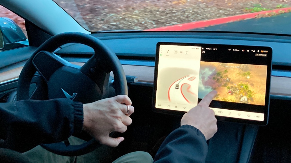 Vince Patton plays a video game in his Tesla