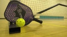 A pickleball paddle and ball are seen at a Pickleball Yorkton court. (Luke Simard/CTV News) 