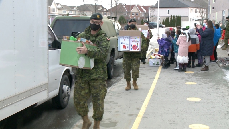 Soldiers carry boxes of non-perishable items from a food drive at Vimy Ridge Public School. Students donated so much, the army was called in to help bring it to the food bank. (Jim O'Grady/CTV News Ottawa)