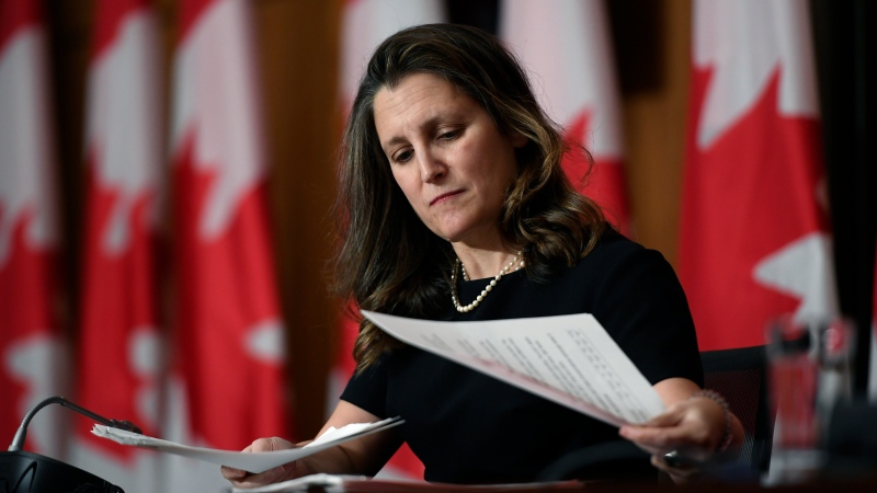 Deputy Prime Minister and Minister of Finance Chrystia Freeland adjusts her notes during a joint news conference in Ottawa, on Monday, Dec. 13, 2021. THE CANADIAN PRESS/Justin Tang 