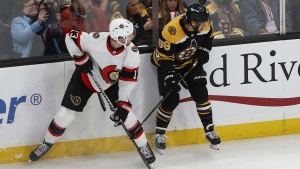 Ottawa Senators' Zach Sanford (13) and Boston Bruins' David Pastrnak look for the puck during the second period of an NHL hockey game Tuesday, Nov. 9, 2021, in Boston. (AP Photo/Winslow Townson) 