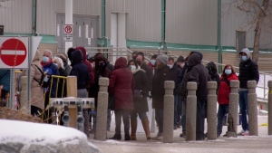 People lined up waiting to get their COVID-19 booster shot at Prairieland Park in Saskatoon on Dec. 20, 2021. (Chad Hills/CTV News)