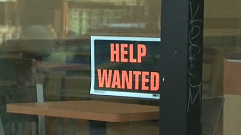 A help-wanted sign in the window of a Toronto fast-food restaurant.