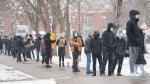 People wait in line to receive a COVID-19 test in Montreal, Thursday, December 23, 2021, as the COVID-19 pandemic continues in Canada and around the world. THE CANADIAN PRESS/Graham Hughes 