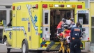 Paramedics transfer a person from an ambulance into a hospital, amid the global COVID-19 pandemic, in Montreal, Saturday, Dec. 18, 2021. (THE CANADIAN PRESS/Graham Hughes)