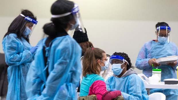 A nurse administers a COVID-19 vaccine at a mass vaccination clinic in Mississauga, Ont., Friday, Dec. 24, 2021. THE CANADIAN PRESS/Chris Young 