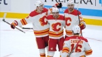 Calgary Flames left wing Johnny Gaudreau, second from left, celebrates with teammates after he scored a goal against the Seattle Kraken during the first period Thursday in Seattle. (AP Photo/Ted S. Warren)