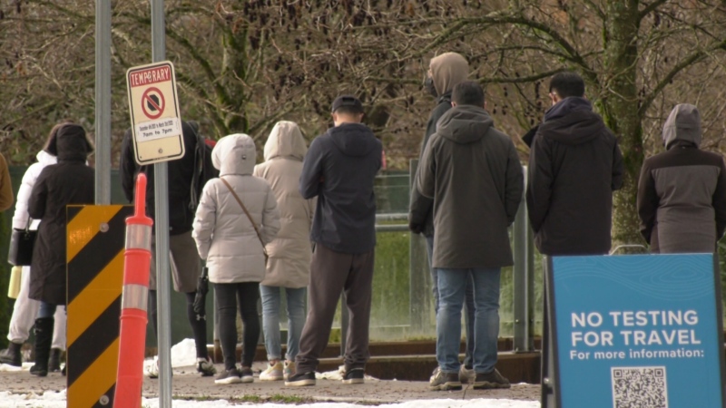 People wait in line to get a COVID-19 test in Vancouver on Jan. 3, 2022.